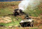 Two confiscated destroyed Serbian Army BOV-VP Wheeled Armored Personnel Carrier (APC) sit in a field. - wikimedia commons